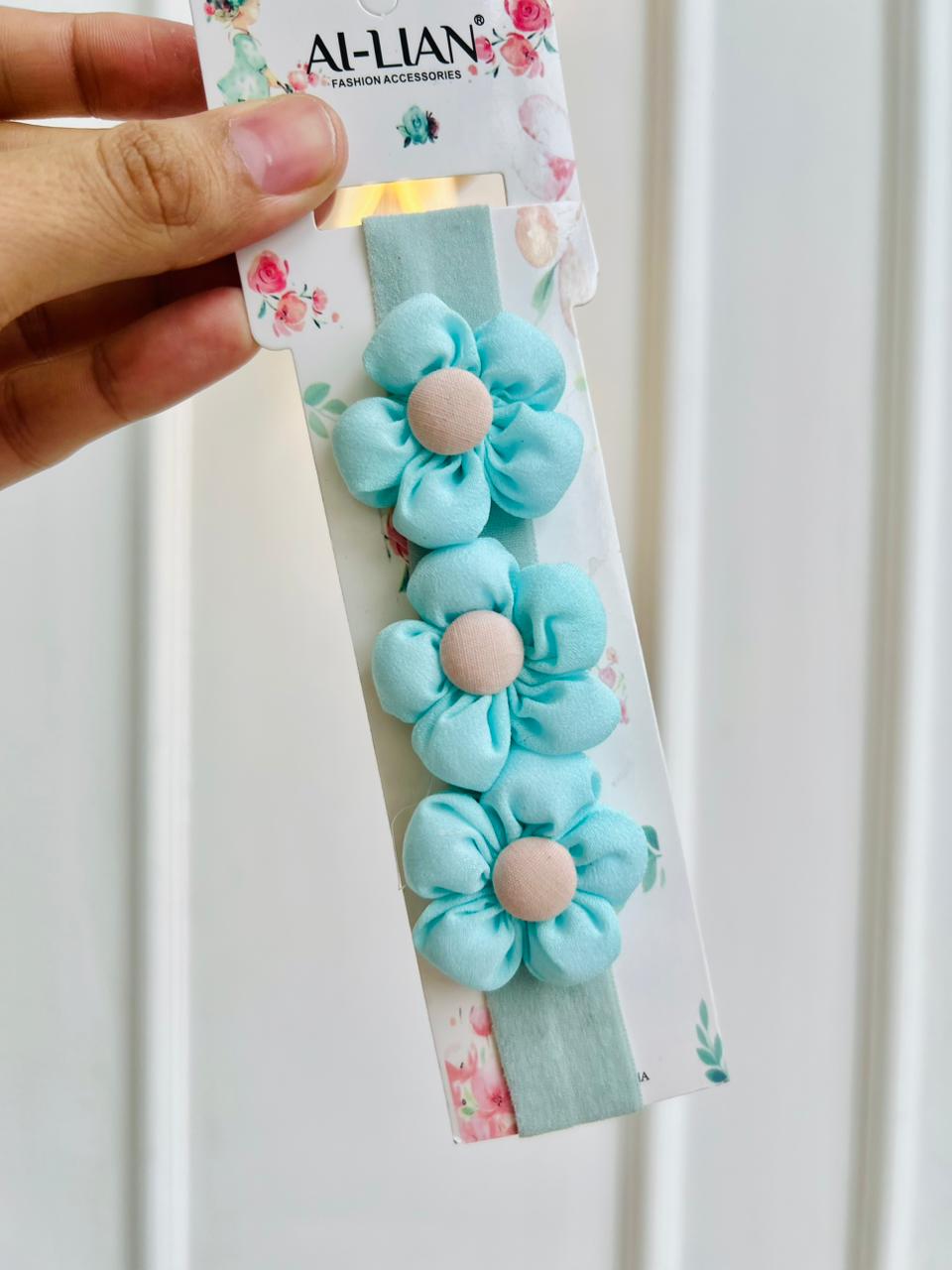 DIADEMA ELASTICA PARA BEBÉ CON FLORES CELESTES