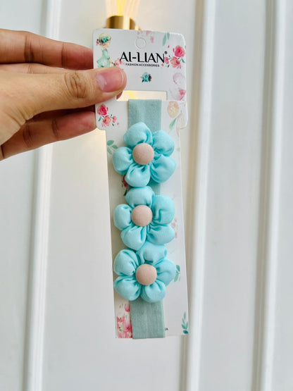 DIADEMA ELASTICA PARA BEBÉ CON FLORES CELESTES