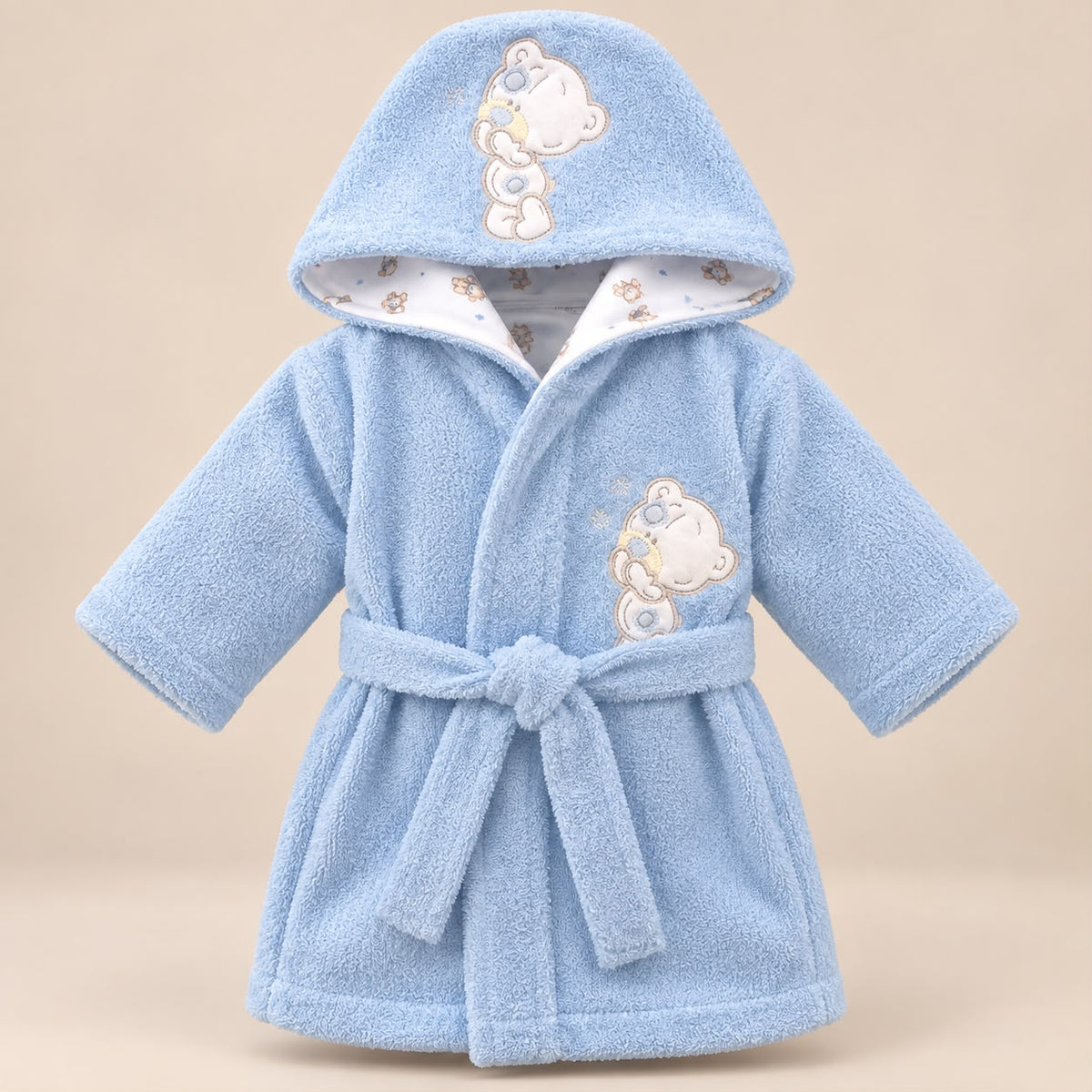 Bebé con bata de baño azul con capucha e interior estampado