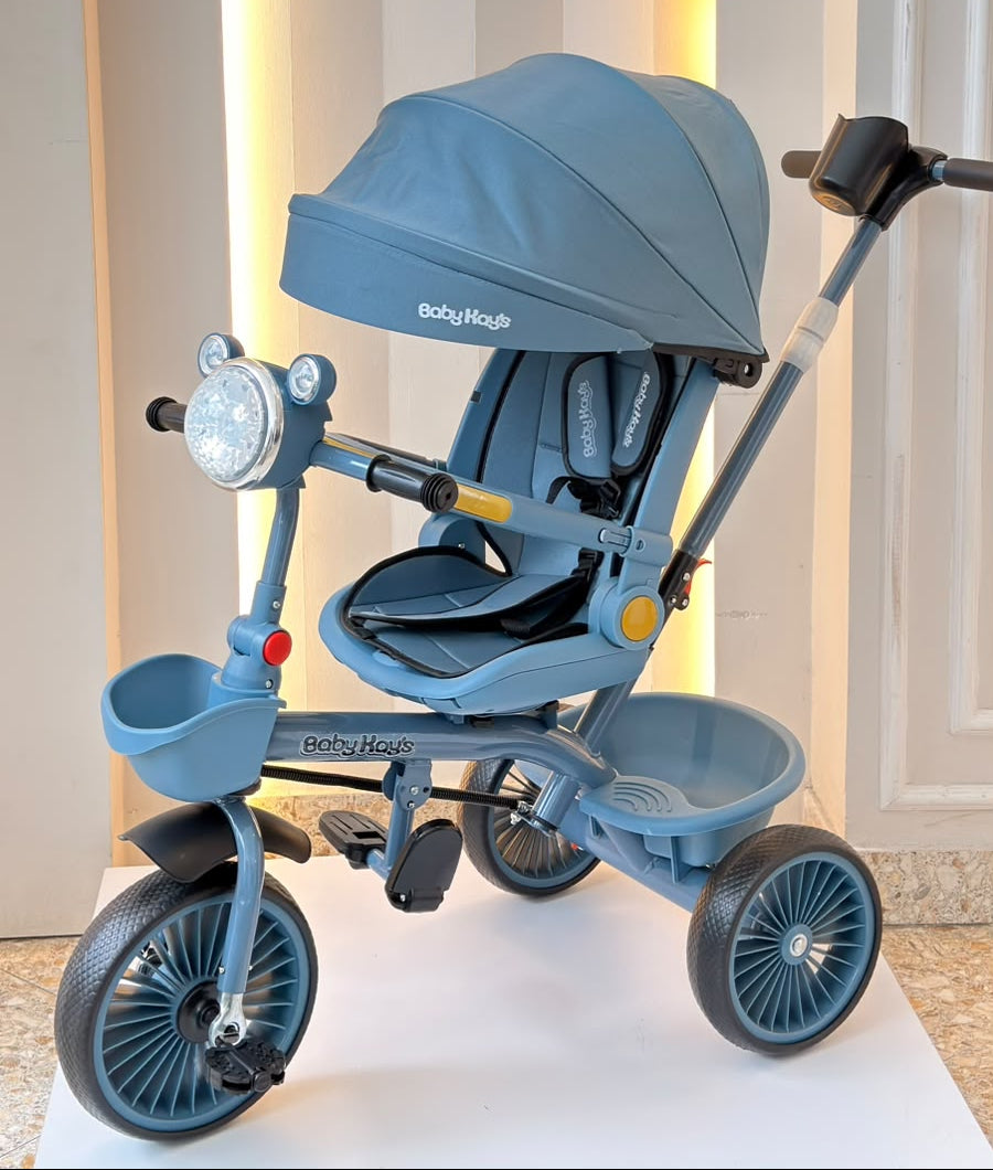 Triciclo infantil azul con capota, asiento acolchado y manija de empuje
