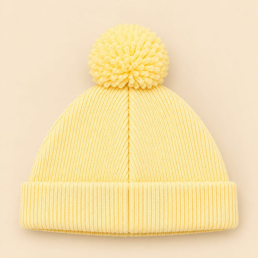 Gorro tejido para bebé amarillo pastel con pompón