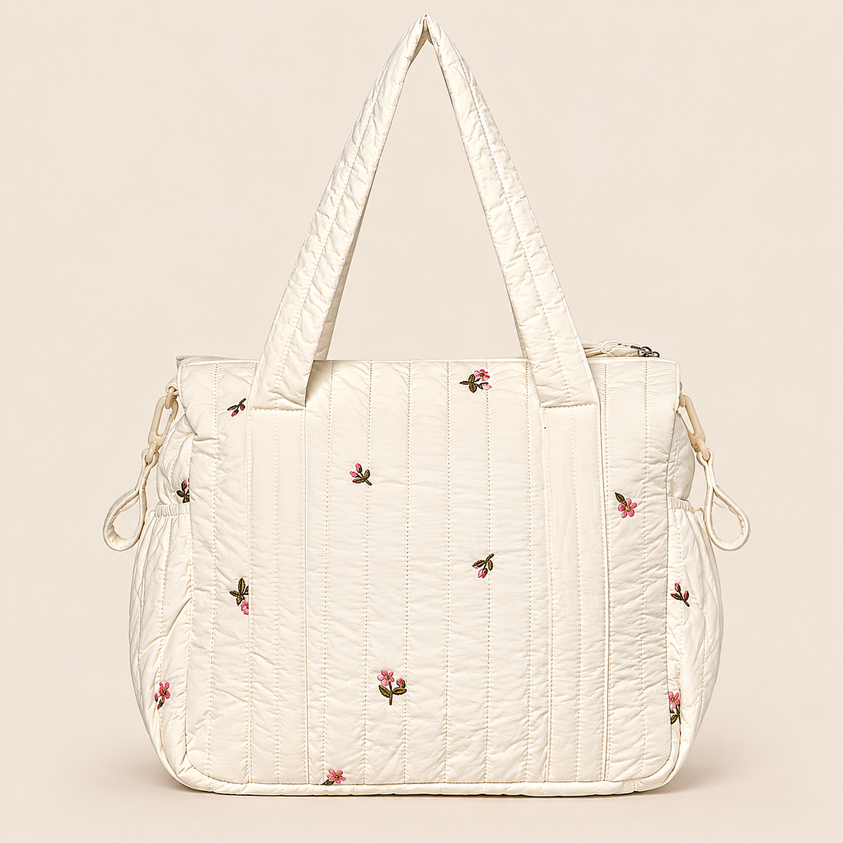 Pañalera para bebé crema acolchada con diseño floral, vista posterior