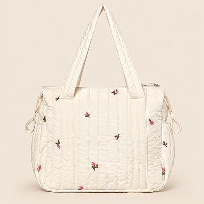 Pañalera para bebé crema acolchada con diseño floral, vista posterior