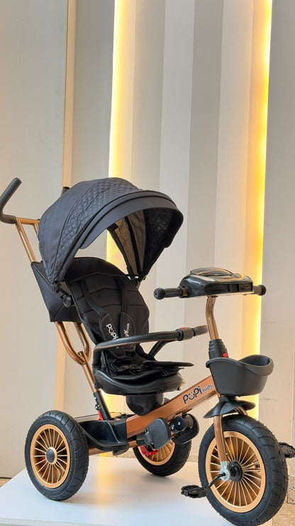 Triciclo Pupi Kids cobrizo y negro con manija posterior, vista de perfil